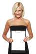 Photo: Smiling woman standing showing white paper clipboard Smiling woman standing showing white paper clipboard