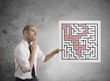 Businessman with solutions of maze