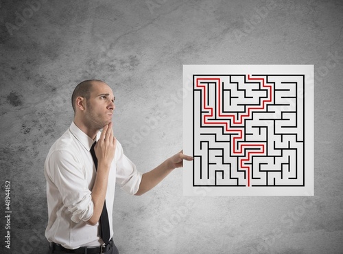 Photo: Businessman with solutions of maze Businessman with solutions of maze