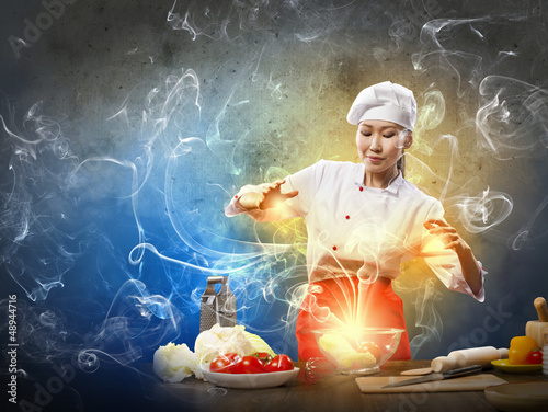 Photo: Asian female cooking with magic Asian female cooking with magic