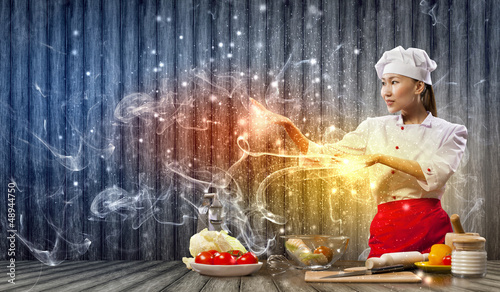 Photo: Asian female cooking with magic Asian female cooking with magic