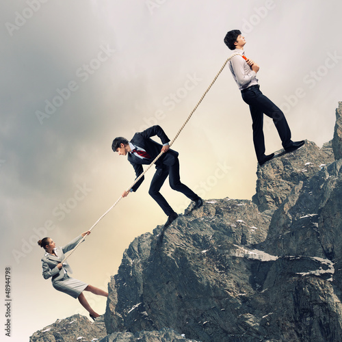 Photo: Three business people pulling rope Three business people pulling rope