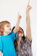 Little cute boy and his mother shows hand up
