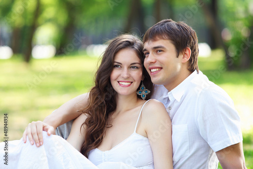 Photo: Young love Couple smiling under blue sky Young love Couple smiling under blue sky