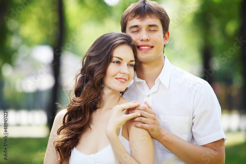 Photo: Young love Couple smiling under blue sky Young love Couple smiling under blue sky