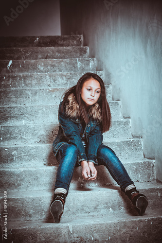 Photo: portrait of a sad teenage girl looking thoughtful about trouble portrait of a sad teenage girl looking thoughtful about trouble