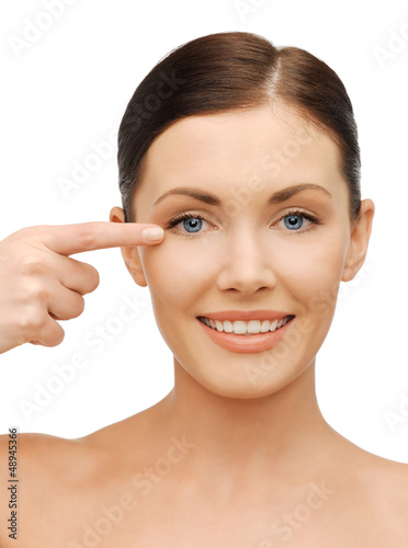 Photo: beautiful woman pointing to eye beautiful woman pointing to eye