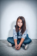 portrait of a sad teenage girl looking thoughtful about troubles