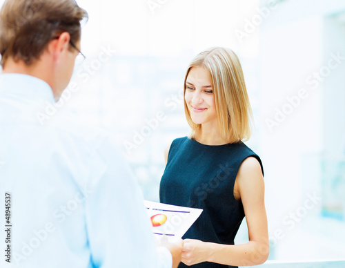 Photo: Two young business collegues. Two young business collegues.