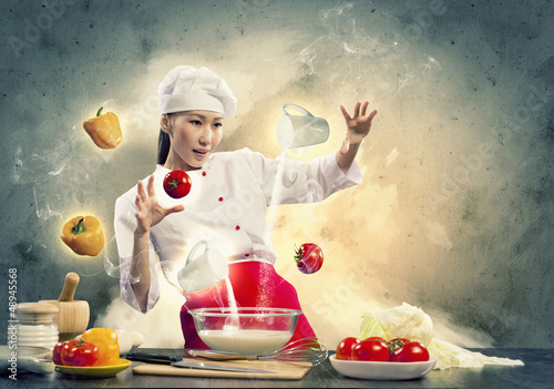 Photo: Asian female cooking with magic Asian female cooking with magic