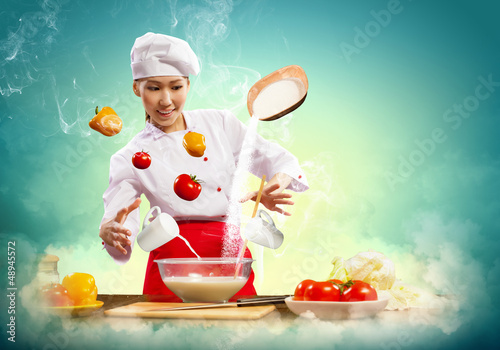 Photo: Asian female cooking with magic Asian female cooking with magic
