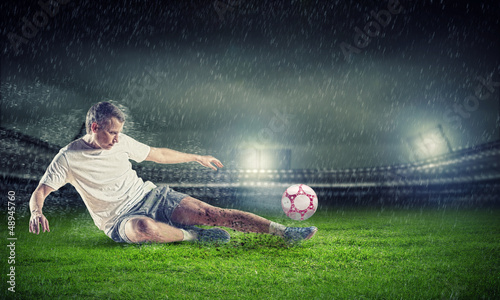Photo: football player striking the ball football player striking the ball