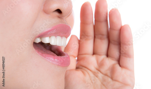 Photo: Yelling woman mouth close up isolated on white background Yelling woman mouth close up isolated on white background