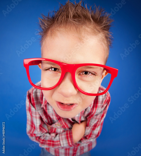 Photo: Funny five years old boy with expressive face, misbehave concept Funny five years old boy with expressive face, misbehave concept