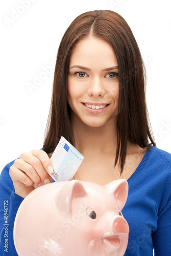 Photo: lovely woman with piggy bank and money lovely woman with piggy bank and money