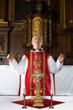 Priest praying during mass
