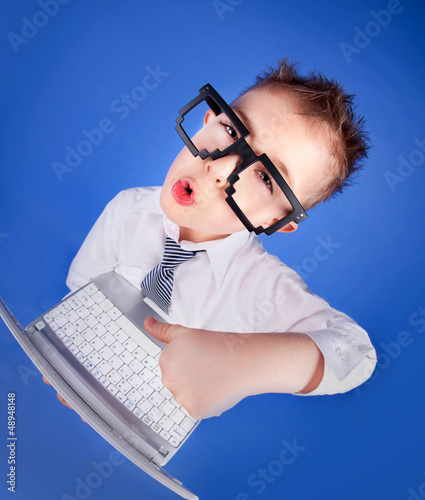 Photo: Smart five years old boy with a laptop computer Smart five years old boy with a laptop computer