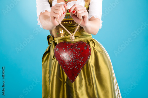 Photo: Young woman in traditional clothes - dirndl or tracht Young woman in traditional clothes - dirndl or tracht
