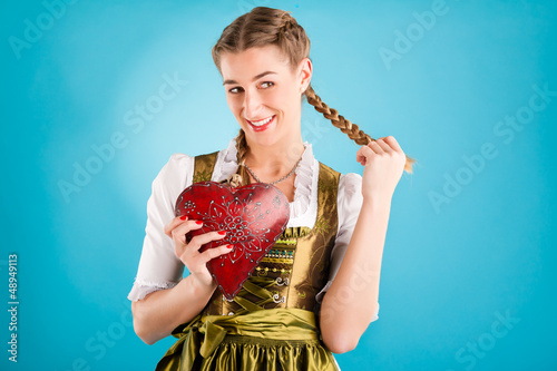 Photo: Young woman in traditional clothes - dirndl or tracht Young woman in traditional clothes - dirndl or tracht