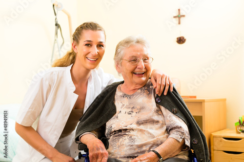 Photo: Young nurse and female senior in nursing home Young nurse and female senior in nursing home