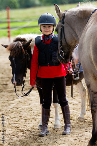 Photo: Horses and lovely equestrian girl Horses and lovely equestrian girl