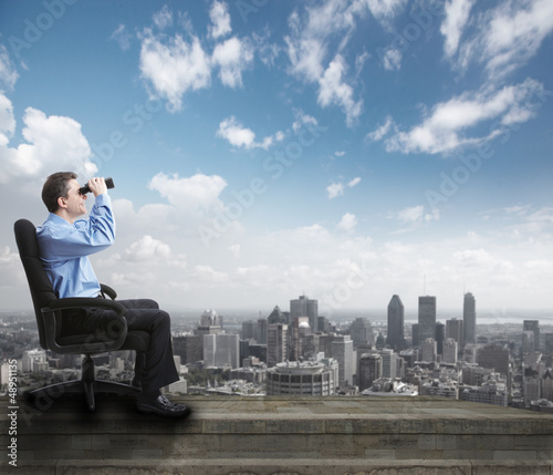 Photo: Businessman with binoculars. Businessman with binoculars.