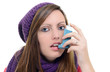 Woman with asthma using an asthma inhaler