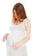 Beautiful pregnant woman in white dress