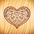 Brown ornate vector heart on wooden background