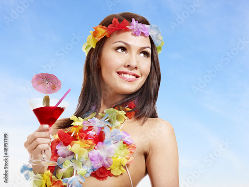 Photo: Woman in hawaii costume drink juice. Woman in hawaii costume drink juice.