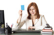 Photo: Manager female holding a credit card Manager female holding a credit card