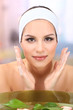 Young woman washing her face. Conceptual photo: make-up remover