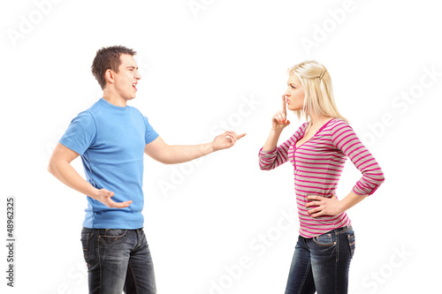 Photo: Young man shouting and woman gesturing silence Young man shouting and woman gesturing silence