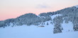 Photo: Sunset over fir trees by winter, Jura mountain, Switzerland Sunset over fir trees by winter, Jura mountain, Switzerland