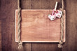 Wooden valentine background with hearts hanging on rope