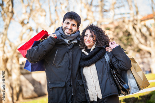 Photo: Happy Young Couple with Shopping Bags Happy Young Couple with Shopping Bags