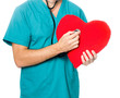 Photo: doctor examining a red heart doctor examining a red heart