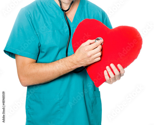Photo: doctor examining a red heart doctor examining a red heart