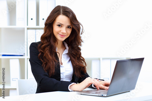 Photo: Young busines woman with notebook Young busines woman with notebook