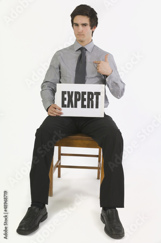 Photo: Man Holding A Sign That Says Expert Man Holding A Sign That Says Expert