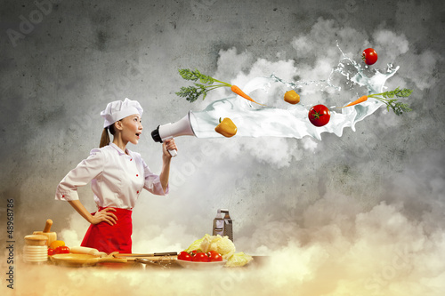 Photo: Asian female cook holding megaphone Asian female cook holding megaphone
