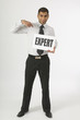 Man Holding A Sign That Says Expert