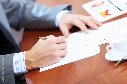 Photo: Hands of businessman writing Hands of businessman writing