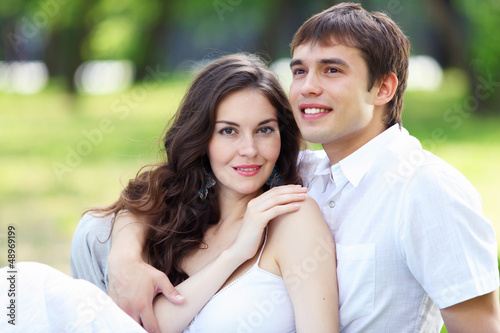 Photo: Young love Couple smiling under blue sky Young love Couple smiling under blue sky
