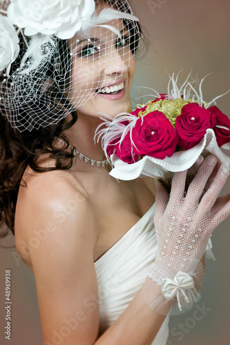 Photo: Beautiful bride with red roses. Beautiful bride with red roses.
