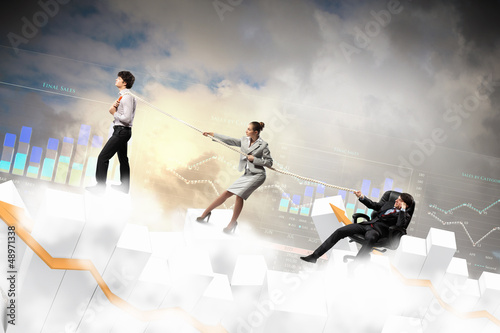 Photo: Three business people pulling rope Three business people pulling rope