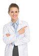 Photo: Happy medical doctor woman pointing on copy space Happy medical doctor woman pointing on copy space