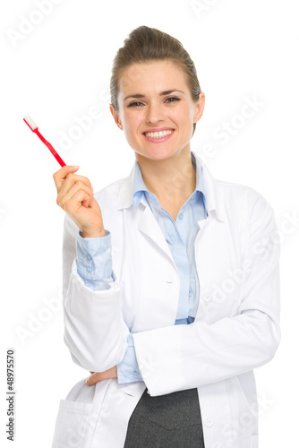 Photo: Happy medical doctor woman holding toothbrush Happy medical doctor woman holding toothbrush
