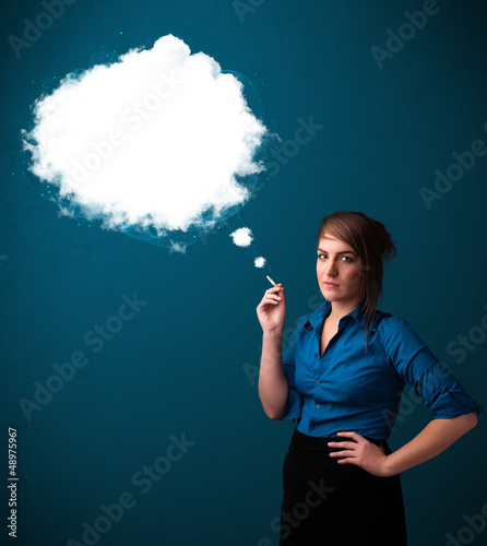 Photo: Young woman smoking unhealthy cigarette with dense smoke Young woman smoking unhealthy cigarette with dense smoke