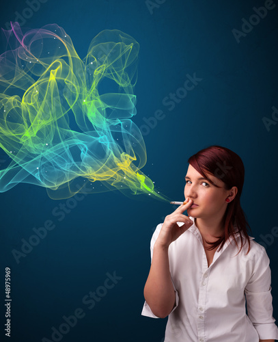 Photo: Pretty lady smoking cigarette with colorful smoke Pretty lady smoking cigarette with colorful smoke